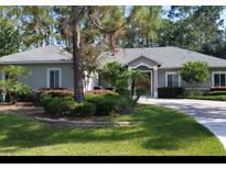 Charming single-story home with meticulously landscaped front yard, mature trees, and welcoming curb appeal at 14641 Henson Rd, Orlando, FL 32832