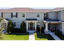 Charming townhome featuring a well-manicured lawn, covered entryway, and neutral exterior paint scheme at 3055 Aqua Virgo Loop # 47, Orlando, FL 32837