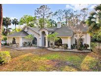 Charming single-story home boasting mature landscaping, a gray roof, and a welcoming front entrance at 322 Harbor Trl, Enterprise, FL 32725