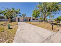Charming single-story home with a long driveway and a well-maintained front yard at 3706 Wade Rd, Orlando, FL 32808