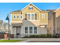 Charming two-story home with manicured lawn and black metal fence at 543 Wishbone Ln, Lake Mary, FL 32746