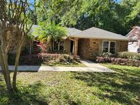 Charming brick home featuring a stone walkway and mature landscaping at 736 Silverwood Dr, Lake Mary, FL 32746
