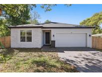 Charming single-story home featuring brick accents, a well-maintained lawn, and an attached two-car garage at 851 W 24Th Pl, Sanford, FL 32771