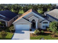 Charming one-story home featuring a well-maintained lawn and a two-car garage at 15746 Autumn Glen Ave, Clermont, FL 34714