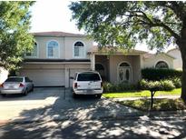 Charming two-story home with a well-manicured front lawn and a two-car garage at 2543 Windsorgate Ln, Orlando, FL 32828