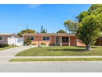 Charming single-story home featuring a well-maintained lawn and a welcoming entrance at 825 Keats Ave, Orlando, FL 32809