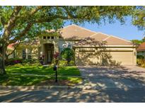 Charming single-story home with a well-manicured lawn and a spacious three-car garage at 8912 Heritage Bay Cir, Orlando, FL 32836