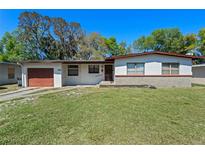 Charming single-story home featuring a well-maintained lawn and a one-car garage at 1807 Yorkshire Dr, Winter Park, FL 32792