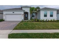 Charming single-story home featuring a 2-car garage, lush lawn, and a welcoming front porch at 2732 Norway Maple Ct, Ocoee, FL 34761