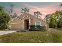 Charming single Gathering home boasts a two-car garage and a well-maintained lawn at 3199 Quail Dr, Deltona, FL 32738