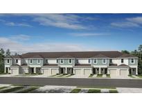 New townhome construction featuring a stylish exterior with modern design elements and well-maintained landscaping at 3550 Mayfair St, Kissimmee, FL 34758