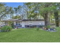 Charming single-story home with a well-maintained front yard and mature trees at 4482 Se 142Nd St, Summerfield, FL 34491