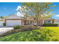 Charming single-Gathering home with brick accents, lush landscaping, and a welcoming front porch at 5263 Jade Cir, Belle Isle, FL 32812