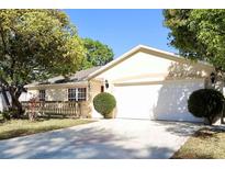 Charming single-story home with a well-maintained front yard and two-car garage at 7 Sequoia Way, Kissimmee, FL 34758