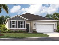 Charming single-story home with a well-manicured lawn, stone accents, and a two-car garage at 866 Pebble Crest Ln, Eagle Lake, FL 33839