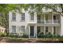 Charming two-story townhouse with a balcony, manicured landscaping, and beautiful curb appeal at 1563 Common Way Rd, Orlando, FL 32814