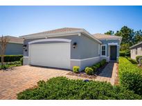 Charming single Gathering home showcasing a two car garage and landscaped front yard at 193 Old Moss Cir, Deland, FL 32724