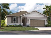 Charming one-story home featuring stone accents, a two-car garage, and well-maintained landscaping at 921 Pearlwood Loop, Eagle Lake, FL 33839