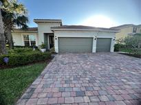 Charming single-story home with a two-car garage and landscaped front yard at 12184 Aztec Rose Ln, Orlando, FL 32827