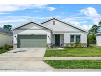 Charming single-Gathering home with a well-manicured lawn and a two-car garage in a quiet neighborhood at 17668 Passionflower Cir, Clermont, FL 34714