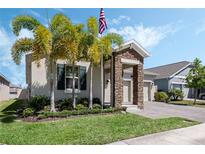 Charming single-Gathering home with stone accents, manicured lawn, and lush palm trees at 1807 Good Neighbor Loop, Kissimmee, FL 34744
