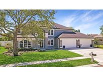 Beautiful two-story home featuring a manicured lawn, a three-car garage, and neutral, modern colors at 2398 Blossomwood Dr, Oviedo, FL 32765