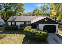 Charming single-story home featuring a one-car garage, tidy landscaping, and neutral colors at 6713 Cherry Rd, Ocala, FL 34472