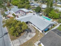 Aerial image highlights a spacious backyard with a swimming pool, patio area, and mature trees at 2829 Aloma Ave, Winter Park, FL 32792