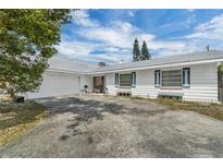 Charming single-story home featuring a garage and a driveway for additional parking at 2829 Aloma Ave, Winter Park, FL 32792