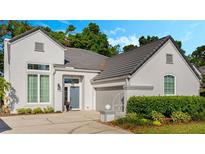 Charming home featuring gray roofing, a gray front door, an attached garage, and landscaped front yard at 1188 Brampton Pl, Lake Mary, FL 32746