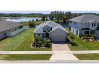Charming single-Gathering home boasts a beautifully landscaped yard and serene water views at 16781 Meadows St, Clermont, FL 34714