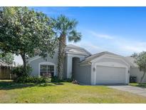 Charming single-Gathering home with a well-manicured lawn and inviting curb appeal on a sunny day at 8310 Fort Thomas Way, Orlando, FL 32822