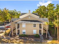 Exterior view of a two story condo building with stairs and walkway at 1013 S Hiawassee Rd # 3628, Orlando, FL 32835