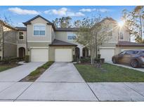 Charming townhome featuring an attached garage and well-maintained landscaping at 1284 Pavia Dr, Apopka, FL 32703