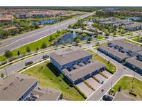 Aerial view showcases well-maintained community with ponds and lush landscaping near roadways at 14432 Orchid Island Dr, Orlando, FL 32827