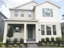 Charming two-story home with a welcoming front porch, attractive landscaping and an inviting walkway at 15872 Moonlight Bay St, Winter Garden, FL 34787