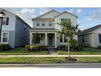 Charming two-story home with a well-manicured lawn and inviting front porch at 15872 Moonlight Bay St, Winter Garden, FL 34787