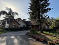 Charming brick home features a well-manicured lawn and mature trees, providing a serene and inviting curb appeal at 285 Ringwood Dr, Winter Springs, FL 32708