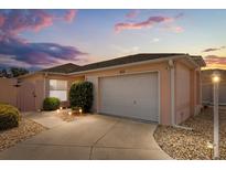 Charming single Gathering home with two-car garage, manicured landscaping, and a cozy, inviting atmosphere at 613 Nuevo Leon Ln, The Villages, FL 32159