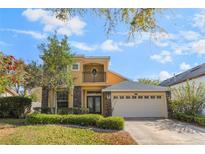 Charming two-story home with a well-manicured lawn, stone accents, and a two-car garage at 10321 Pebblestone Ct, Leesburg, FL 34788