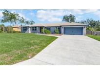 Charming single-story home featuring a well-manicured lawn and attached two-car garage at 1416 Leighton Ave, Lakeland, FL 33803