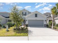 Charming two-story home featuring a large two car garage and beautifully landscaped front yard at 2865 High Pointe St, Clermont, FL 34711