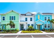 Colorful townhomes featuring unique designs and well-maintained landscaping offer a vibrant community atmosphere at 3192 Caribbean Soul Dr, Kissimmee, FL 34747