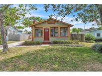 Charming home with an inviting red door, light green paint, and well-maintained front yard at 712 Baffie Ave, Winter Park, FL 32789