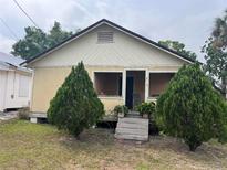 Charming home featuring a covered porch and well-maintained front yard at 718 Avenue L Sw, Winter Haven, FL 33880