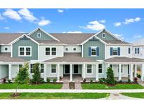 Charming townhome showcasing dual-tone siding, inviting front porches, and well-manicured landscaping at 13532 Autumn Harvest Ave, Winter Garden, FL 34787