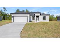 Charming single-story home featuring a two-car garage, neutral color palette and well-maintained landscaping at 16745 Sw 29Th Terrace, Ocala, FL 34473