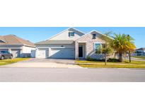 Charming two-story home with a two car garage, stone accents, and a well maintained lawn at 2942 Wordsmith Rd, Kissimmee, FL 34746