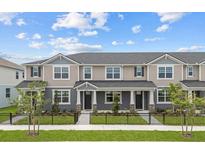 Charming townhomes feature neutral exteriors, well-maintained landscaping, and inviting entrances at 4232 Sadler Rd, Apopka, FL 32712
