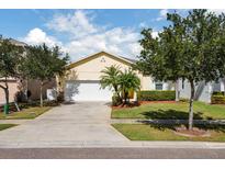 Charming single-story home featuring a two-car garage and well-manicured lawn at 4733 Blue Diamond St, Kissimmee, FL 34746
